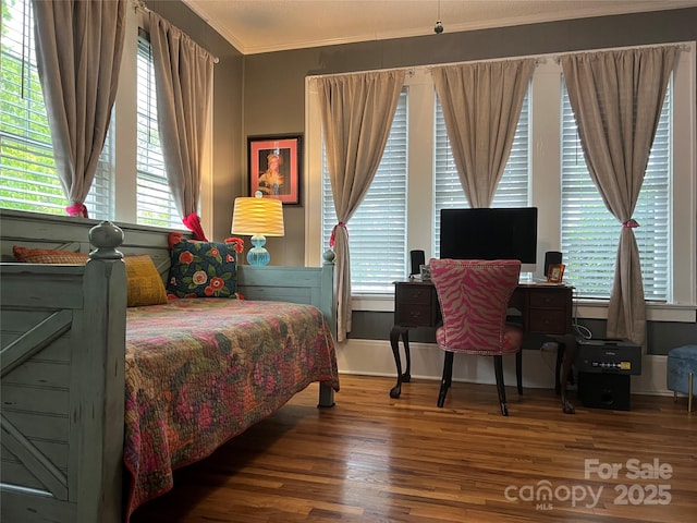 bedroom featuring crown molding, multiple windows, and wood finished floors