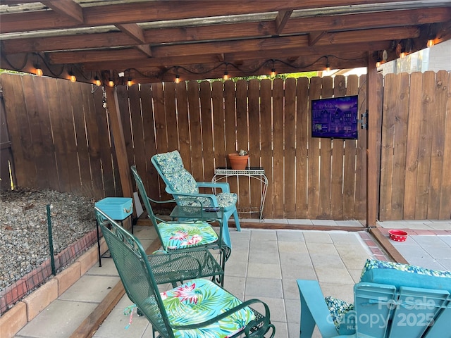 view of patio / terrace featuring fence