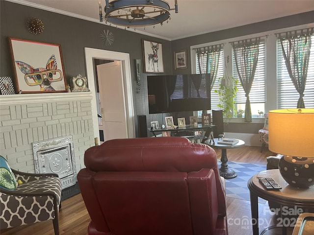 living area featuring ornamental molding, a fireplace, and wood finished floors