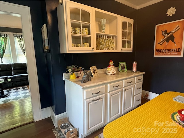 bar with baseboards and wood finished floors