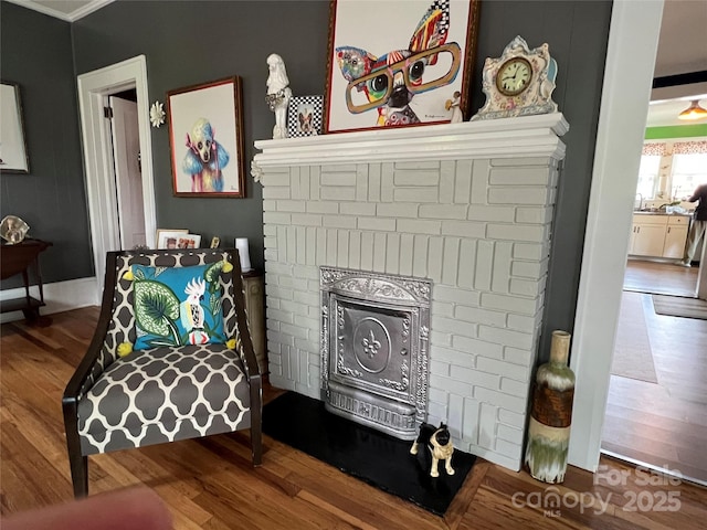 130 Arlington St, Forest City, NC 28043 - detailed view of a brick fireplace, wood finished floors, and crown molding