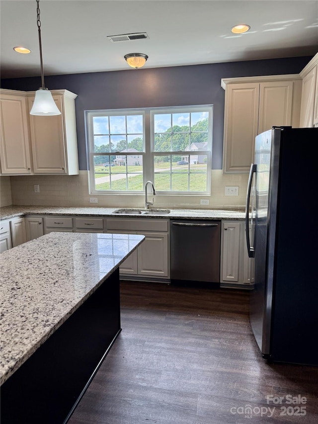 kitchen with a sink, a healthy amount of sunlight, stainless steel appliances, and visible vents