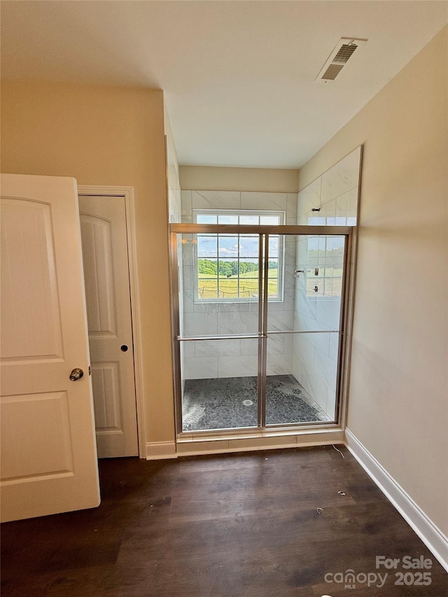 interior space with visible vents, baseboards, and dark wood-style floors