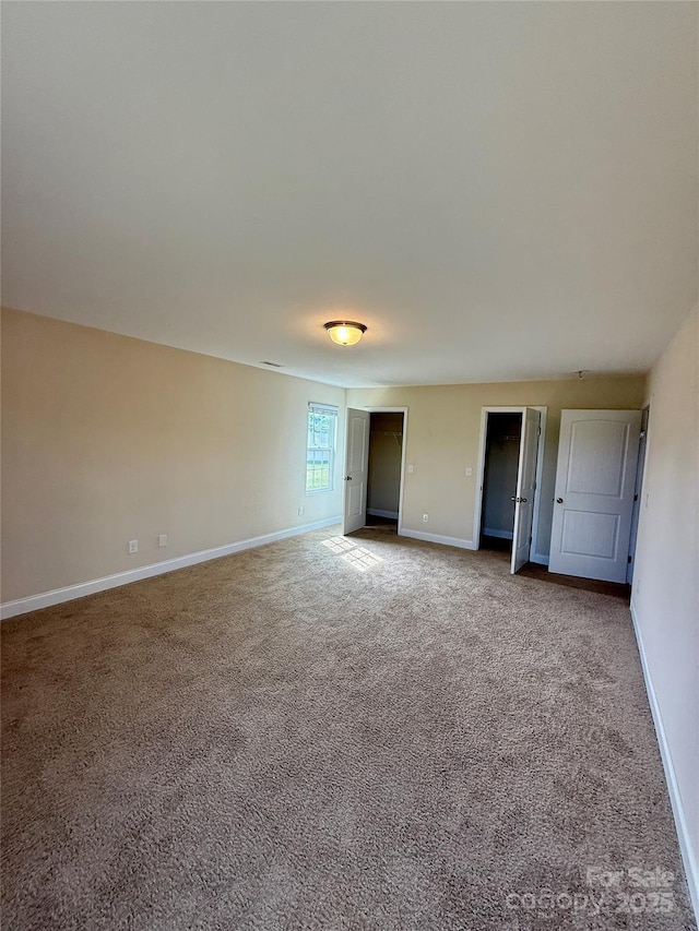 unfurnished bedroom featuring baseboards and carpet