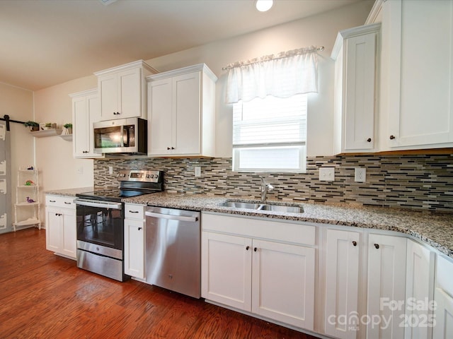 6266 Swanport Rd, Lancaster, SC 29720 - kitchen featuring stainless steel appliances, white cabinetry, a sink, dark wood-style flooring, and backsplash