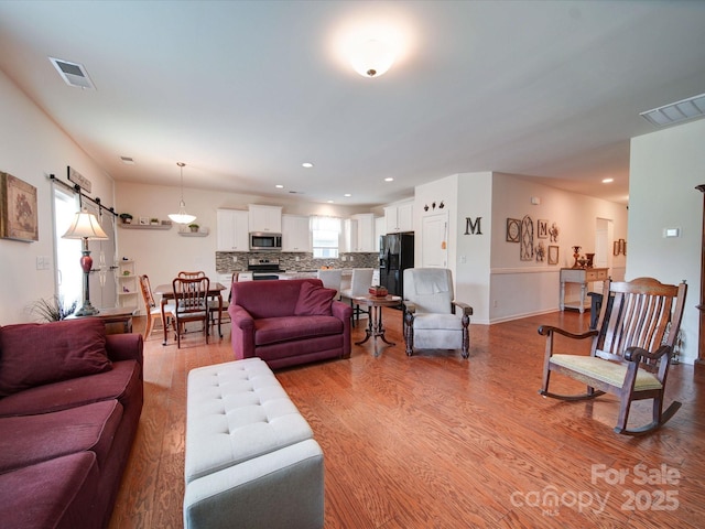6266 Swanport Rd, Lancaster, SC 29720 - living room featuring wood finished floors, recessed lighting, and a barn door