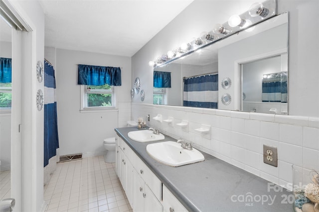 213 Lakeview Dr, Harrisburg, NC 28075 - full bathroom featuring tile patterned flooring, double vanity, toilet, and curtained shower