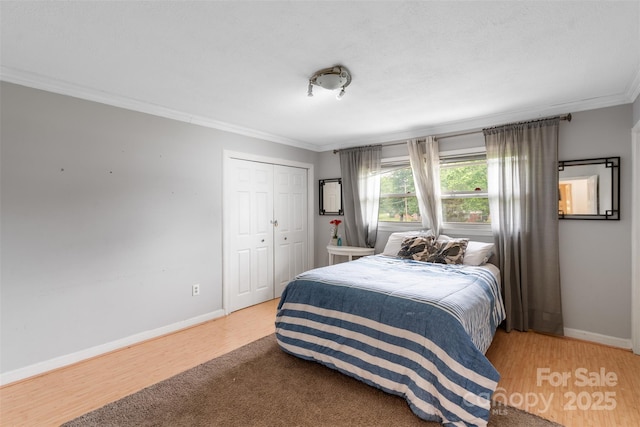 213 Lakeview Dr, Harrisburg, NC 28075 - bedroom with crown molding, wood finished floors, baseboards, and a closet