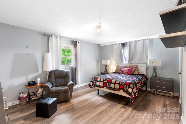 213 Lakeview Dr, Harrisburg, NC 28075 - bedroom with wood finished floors, baseboards, and a textured ceiling
