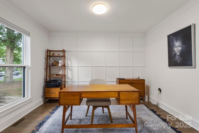 office space with dark wood-style flooring, crown molding, and a decorative wall