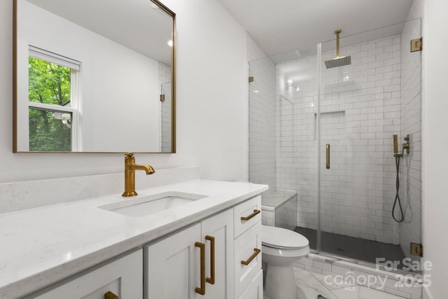 full bath featuring toilet, vanity, a stall shower, and marble look tile flooring
