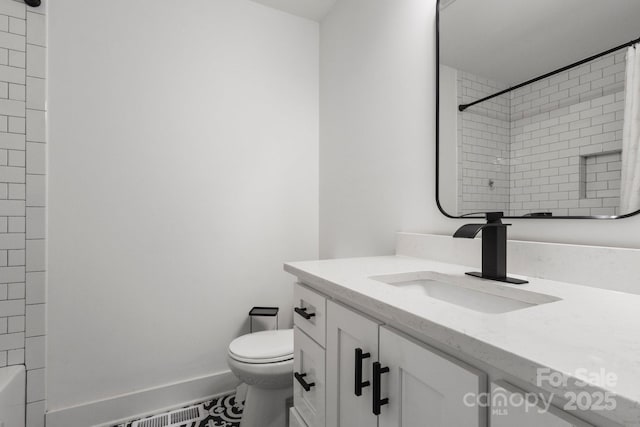 full bathroom featuring toilet, vanity, and baseboards