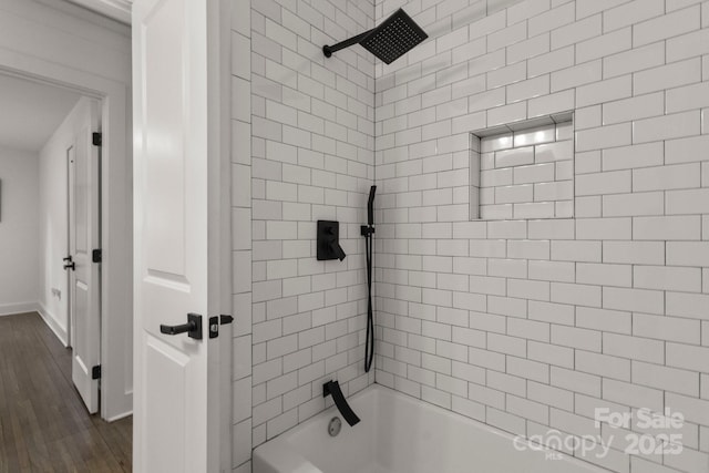 full bathroom featuring bathtub / shower combination, baseboards, and wood finished floors