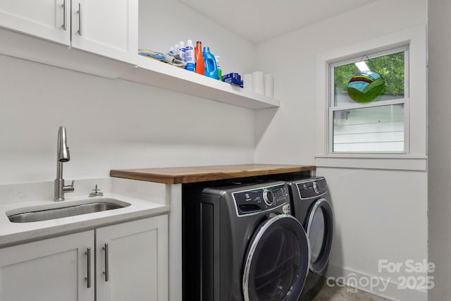 laundry area featuring washer and clothes dryer and cabinet space