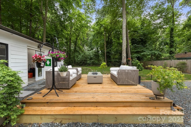 wooden terrace with outdoor lounge area and fence