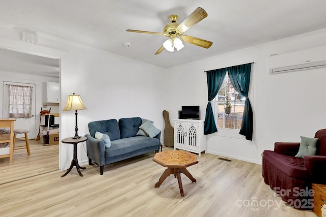 1339 Hill St, Albemarle, NC 28001 - living area with a wall mounted air conditioner, light wood-style floors, and ceiling fan