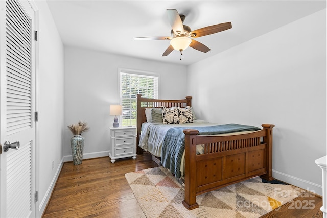 bedroom with wood finished floors, baseboards, and a ceiling fan