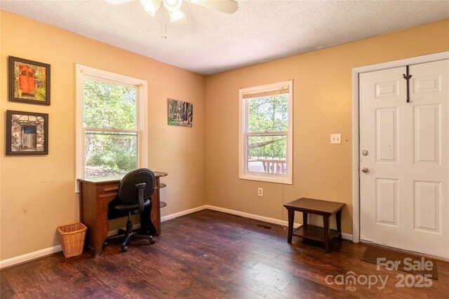 office space featuring baseboards, ceiling fan, a wealth of natural light, and dark wood-type flooring