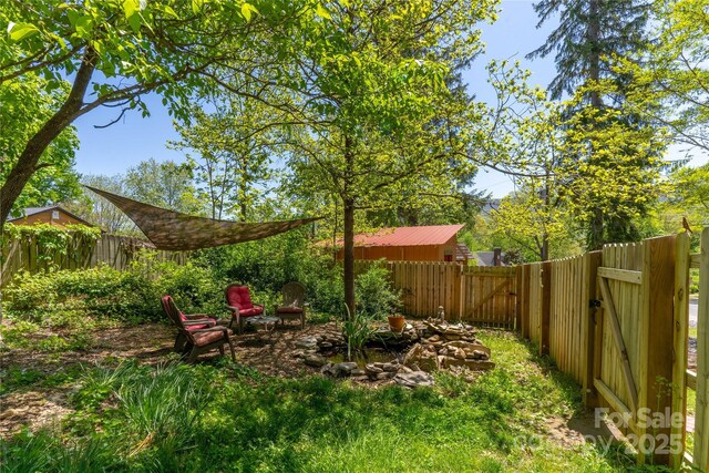 view of yard featuring a gate and a fenced backyard