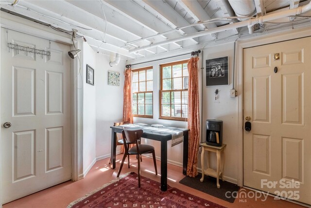 interior space featuring baseboards and carpet