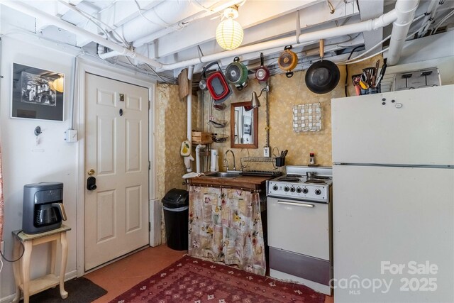 kitchen with white appliances and a sink