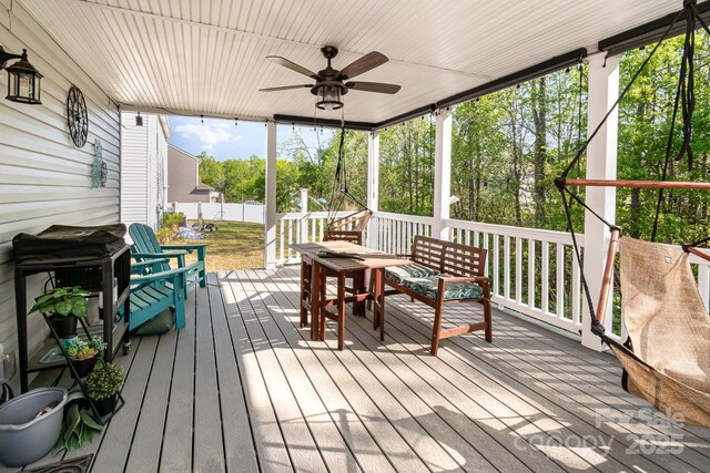 wooden deck with fence and ceiling fan