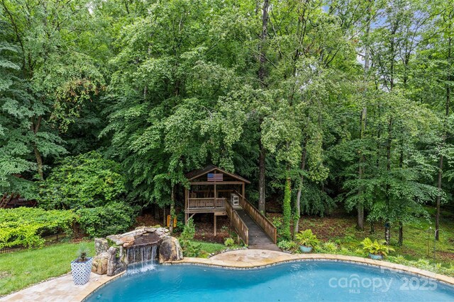 9513 Tresanton Dr, Charlotte, NC 28210 - swimming pool featuring a forest view and stairway
