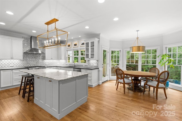9513 Tresanton Dr, Charlotte, NC 28210 - kitchen with wall chimney exhaust hood, ornamental molding, a kitchen island, tasteful backsplash, and white cabinetry