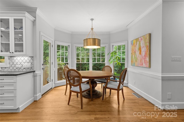 9513 Tresanton Dr, Charlotte, NC 28210 - dining area featuring light wood-style flooring, crown molding, and baseboards