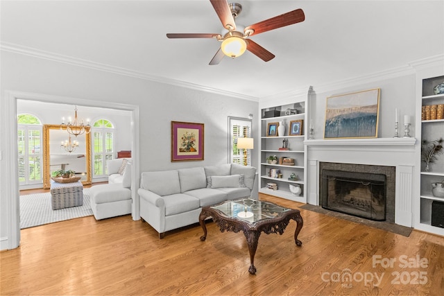 9513 Tresanton Dr, Charlotte, NC 28210 - living area with crown molding, wood finished floors, ceiling fan, built in shelves, and a chandelier