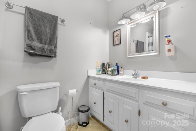 bathroom featuring tile patterned floors, vanity, and toilet