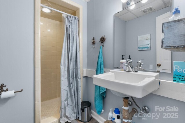 full bathroom featuring visible vents and a tile shower