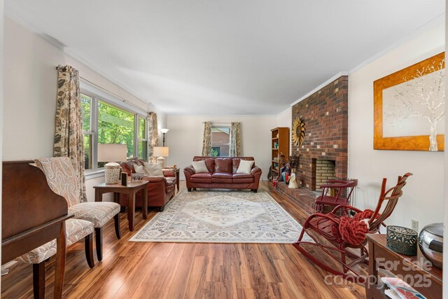 701 5th Ave NE, Conover, NC 28613 - living area with wood finished floors, a brick fireplace, and ornamental molding