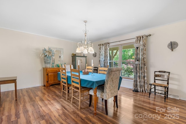 701 5th Ave NE, Conover, NC 28613 - dining space featuring wood finished floors, a chandelier, and baseboards