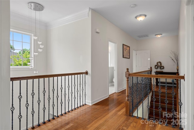 422 Deer Brush Ln, Waxhaw, NC 28173 - hall with an upstairs landing, wood finished floors, baseboards, and crown molding