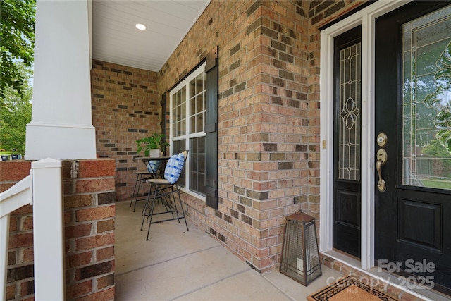 422 Deer Brush Ln, Waxhaw, NC 28173 - view of exterior entry with a porch and brick siding