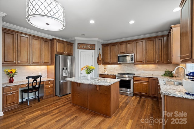 422 Deer Brush Ln, Waxhaw, NC 28173 - kitchen featuring appliances with stainless steel finishes, crown molding, decorative backsplash, a center island, and dark wood-style flooring