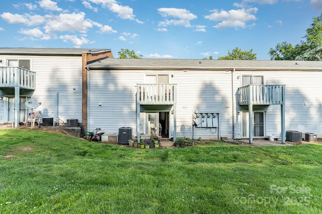 2026 Harvest Ln, Charlotte, NC 28210 - rear view of house featuring a lawn, central AC unit, and a balcony