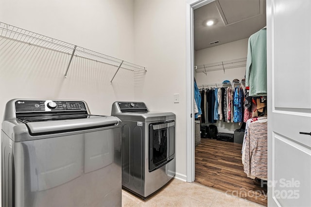 213 Warbler Dr, Wesley Chapel, NC 28110 - laundry room featuring washer and dryer, light tile patterned flooring, and baseboards
