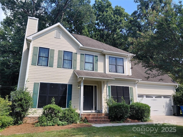 2011 Redwood Dr, Indian Trail, NC 28079 - view of front of property featuring a chimney, a garage, concrete driveway, entry steps, and a shingled roof