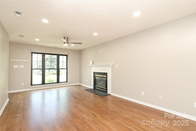 2011 Redwood Dr, Indian Trail, NC 28079 - unfurnished living room with a glass covered fireplace, ceiling fan, wood finished floors, and recessed lighting