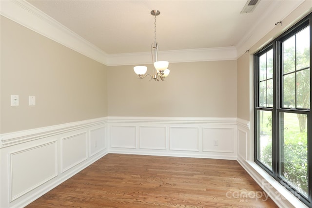 2011 Redwood Dr, Indian Trail, NC 28079 - empty room with a chandelier, crown molding, light wood-style floors, and a wainscoted wall