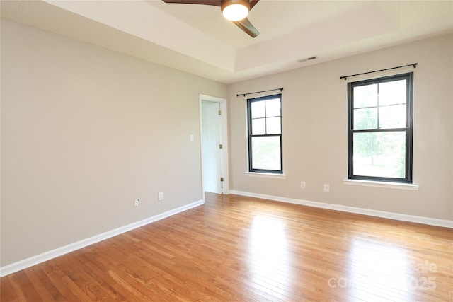 2011 Redwood Dr, Indian Trail, NC 28079 - unfurnished room featuring a raised ceiling, light wood finished floors, and ceiling fan