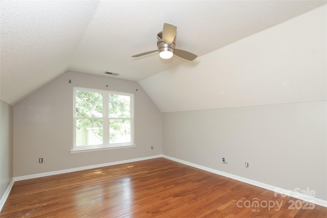2011 Redwood Dr, Indian Trail, NC 28079 - bonus room with wood finished floors, vaulted ceiling, a ceiling fan, and a textured ceiling