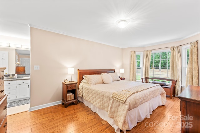 5903 Wm Griffin Rd, Monroe, NC 28112 - bedroom with light wood-style flooring, crown molding, baseboards, and ensuite bath