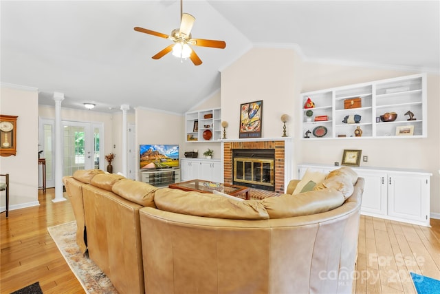5903 Wm Griffin Rd, Monroe, NC 28112 - living room featuring vaulted ceiling, a ceiling fan, light wood-style flooring, and a fireplace