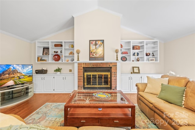 5903 Wm Griffin Rd, Monroe, NC 28112 - living area with lofted ceiling, light wood-type flooring, a brick fireplace, and crown molding