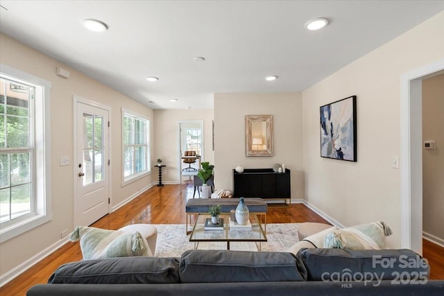 living area featuring baseboards, recessed lighting, and wood finished floors