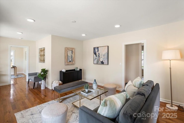 living area with baseboards, recessed lighting, and wood finished floors