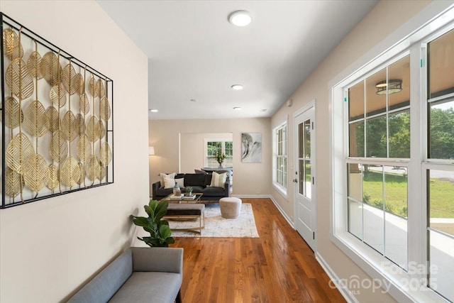 corridor featuring baseboards, french doors, recessed lighting, and wood finished floors
